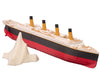Submersible Titanic model ship approaching its glow-in-the-dark iceberg, showing the four gold funnels and red hull, hull break, sink-mode thumb switch.