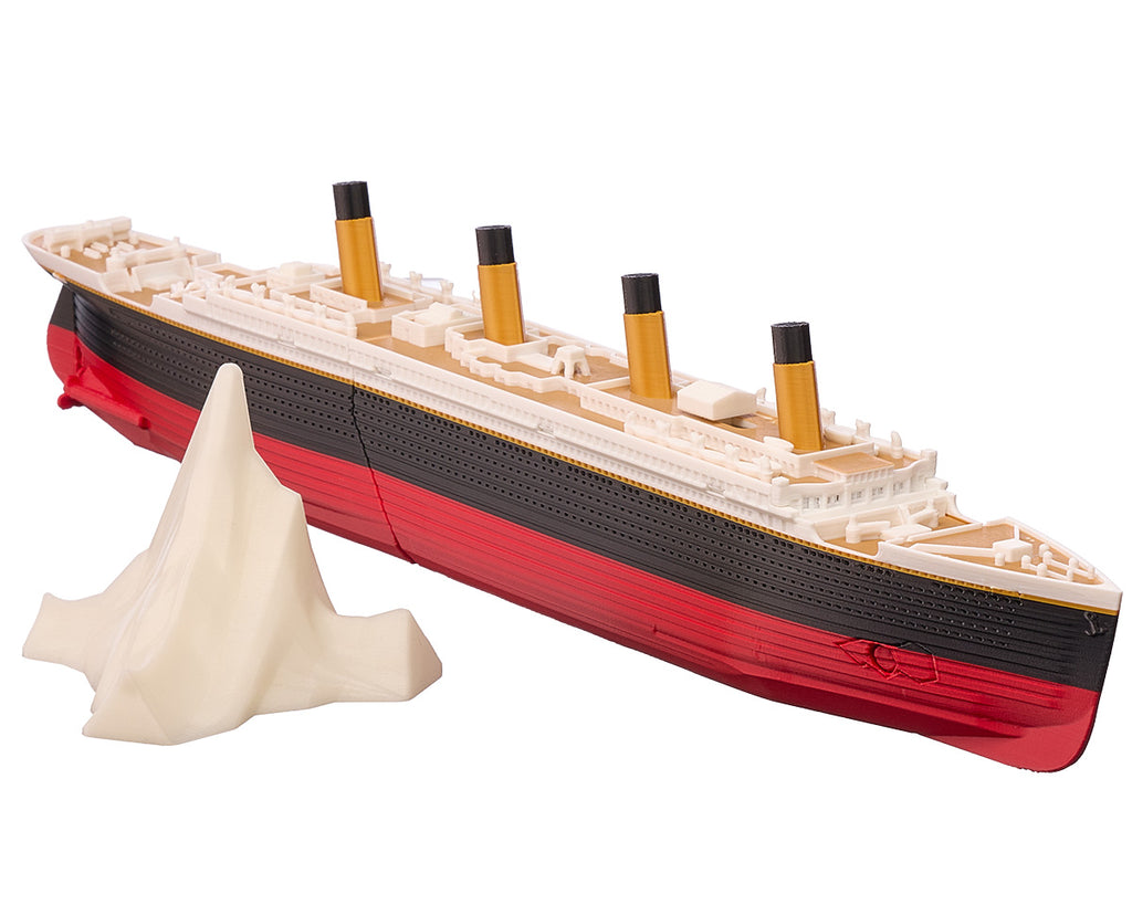 Submersible Titanic model ship approaching its glow-in-the-dark iceberg, showing the four gold funnels and red hull, hull break, sink-mode thumb switch.