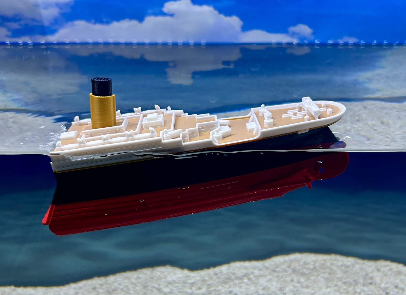 The stern of the Titanic model standing vertical before it goes under