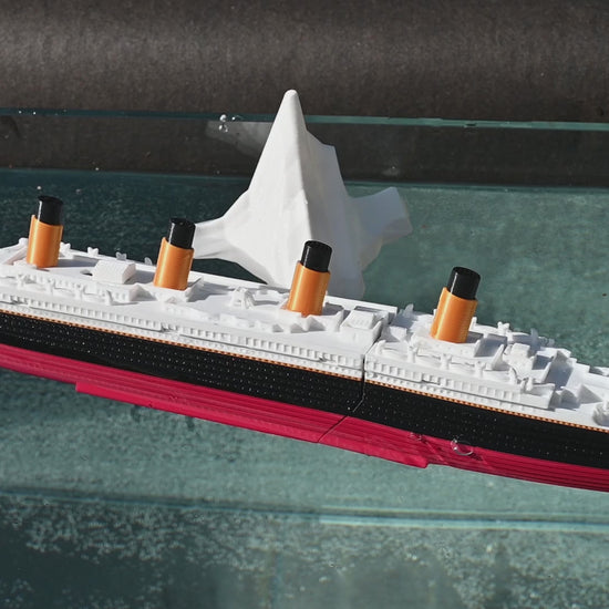 The submersible Starlight Edition Titanic Model floating with Iceberg, then set to "Sink" mode, breaks apart and sinks.